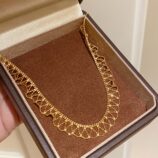 gold plated Sterling silver lace-trimmed necklace displayed in a jewelry box