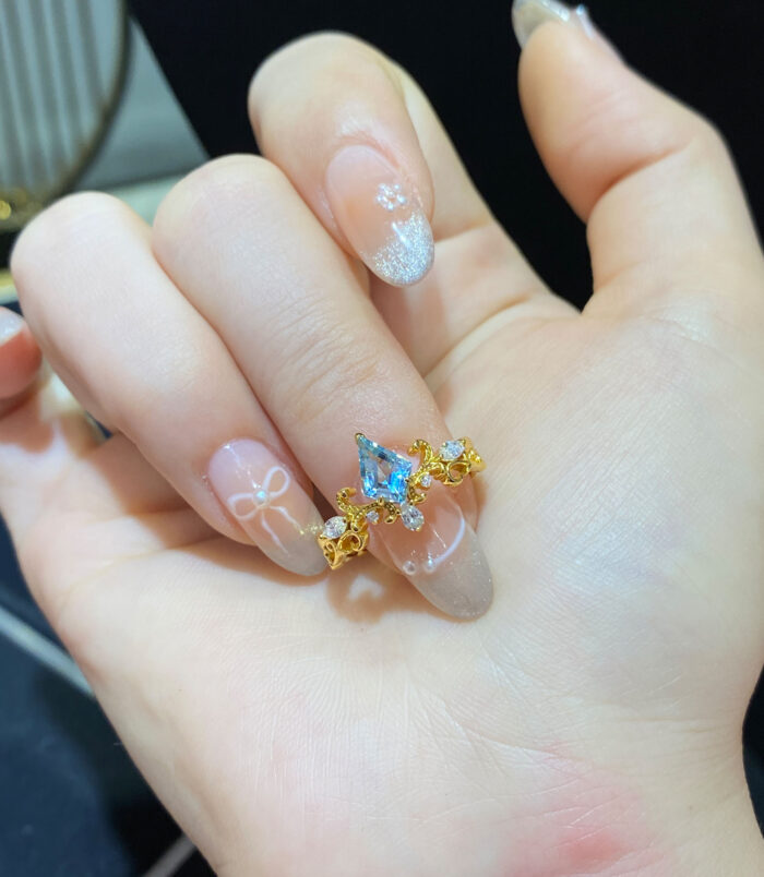 handheld close-up of Sterling silver gold-plated topaz crown ring