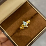 Sterling silver gold-plated topaz crown ring display on a jewelry box