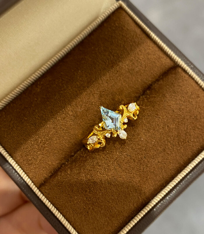Sterling silver gold-plated topaz crown ring display on a jewelry box