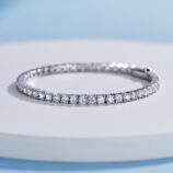 Classic tennis-style sterling silver bracelet with round brilliant-cut clear stones, polished finish.