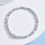 Multi-stone cluster design sterling silver bracelet with round clear stones, polished finish.