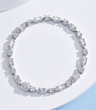 Multi-stone cluster design sterling silver bracelet with round clear stones, polished finish.