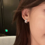 Sleek Sterling Silver Baguette-Cut Cubic Zirconia Huggie Hoop Earrings worn on model's ear