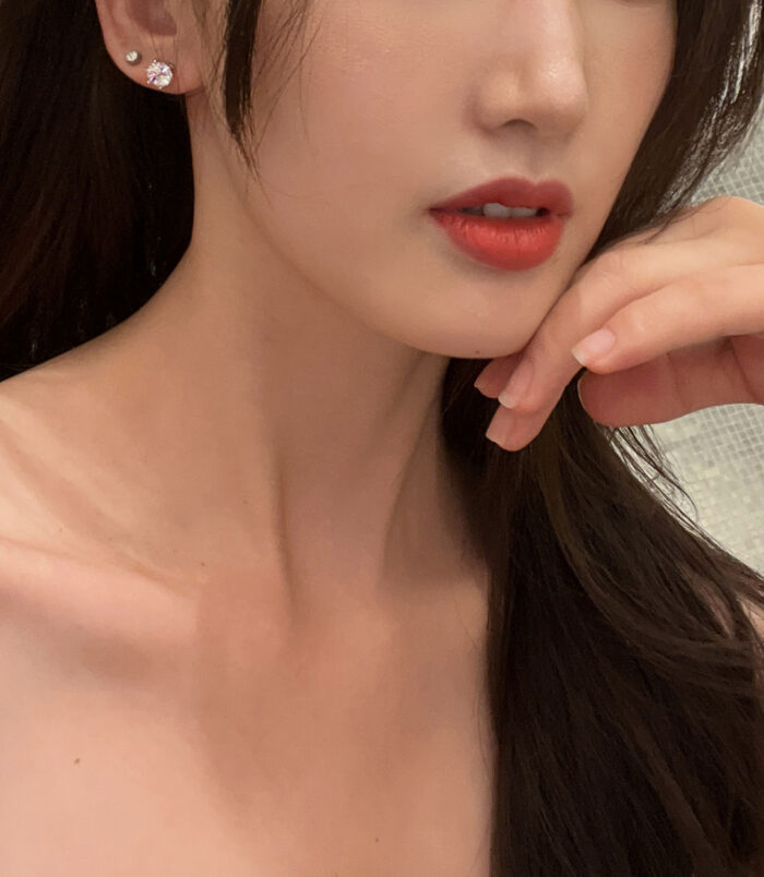 Classic Six-Prong Sterling Silver Stud Earrings model display Classic Six-Prong Sterling Silver Stud Earrings displayed on a model's ear