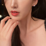 Classic Six-Prong Sterling Silver Stud Earrings worn on a model's ear