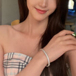 Rhodium plated Double-Row Round-Cut Tennis-Style Sterling Silver jewelry set on a wrist