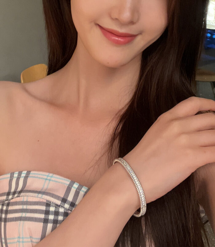 Rhodium plated Double-Row Round-Cut Tennis-Style Sterling Silver jewelry set on a wrist