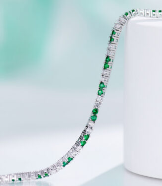 side view of Alternating Green & Clear Stone Tennis-Style Sterling Silver Bracelet, showing its sleek and smooth edges