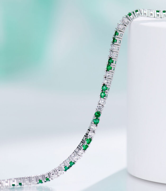 side view of Alternating Green & Clear Stone Tennis-Style Sterling Silver Bracelet, showing its sleek and smooth edges