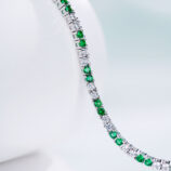 side view of Alternating Green & Clear Stone Tennis-Style Sterling Silver Bracelet, showing its stunning gemstones