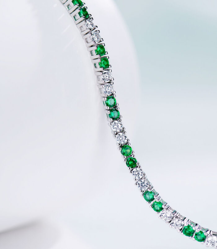 side view of Alternating Green & Clear Stone Tennis-Style Sterling Silver Bracelet, showing its stunning gemstones