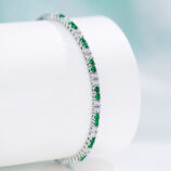 close up side view of Alternating Green & Clear Stone Tennis-Style Sterling Silver Bracelet