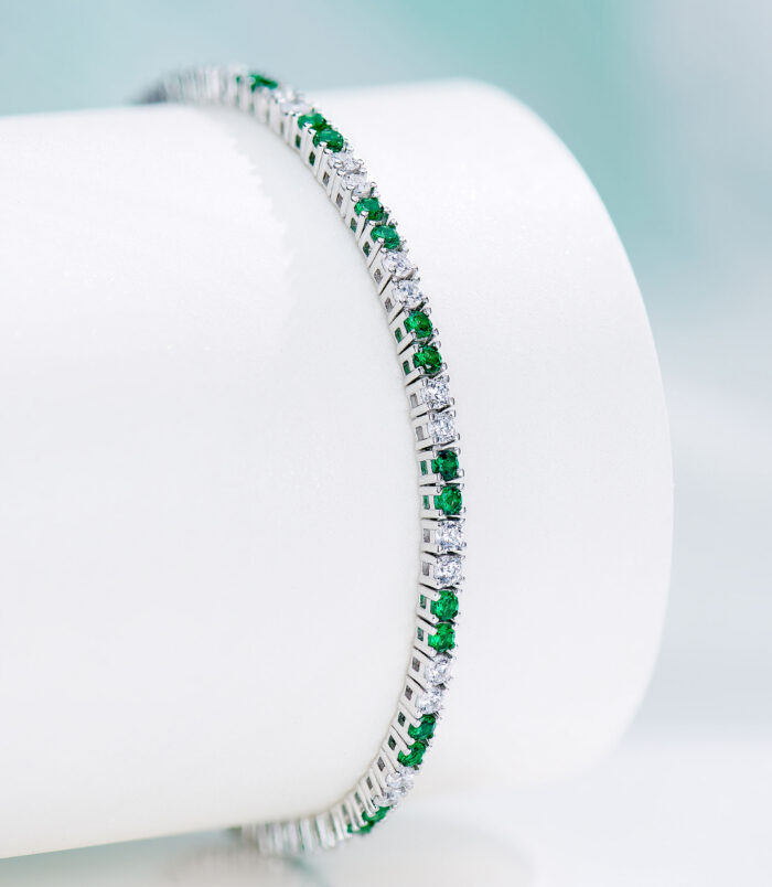 close up side view of Alternating Green & Clear Stone Tennis-Style Sterling Silver Bracelet