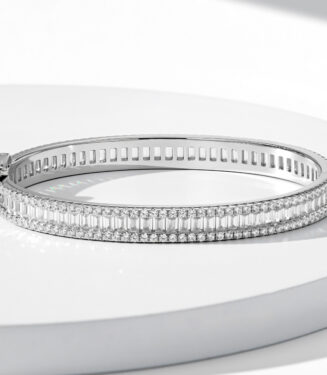 Double-row sterling silver bracelet with baguette-cut clear stones and a hinged clasp.