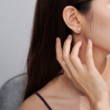 Romantic Heart-Shaped Sterling Silver Stud Earrings worn on a model's ear