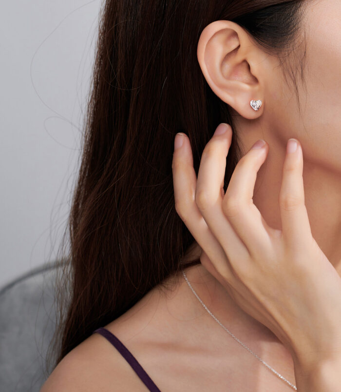 Romantic Heart-Shaped Sterling Silver Stud Earrings wearing effect Romantic Heart-Shaped Sterling Silver Stud Earrings worn on a model's ear