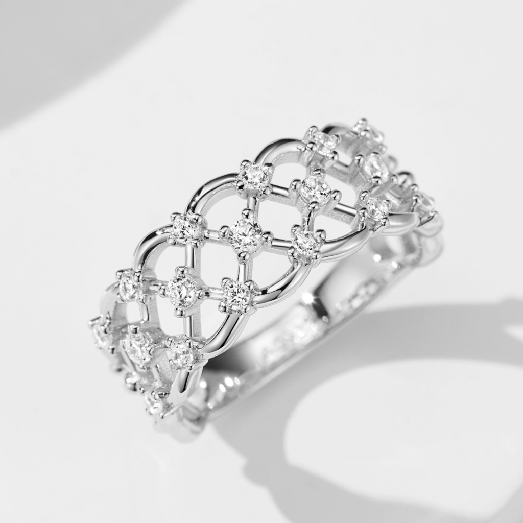 Intricate lattice-style sterling silver ring adorned with multiple round brilliant-cut white cubic zirconia stones, creating a sparkling and sophisticated look perfect for adding a touch of glamour to any outfit.