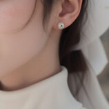 gold plated Elegant Pearl Stud Earrings worn on model's ear