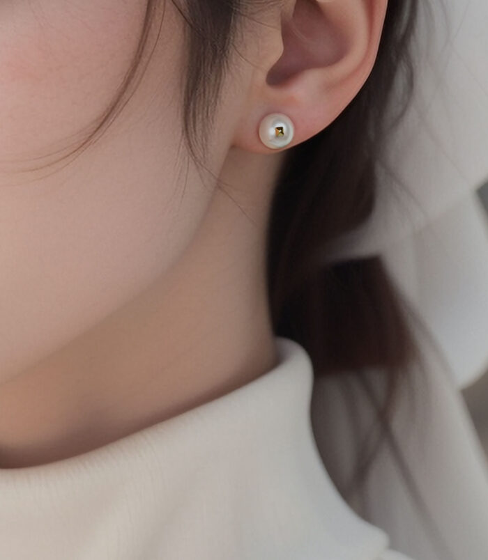gold plated Elegant Pearl Stud Earrings worn on model's ear