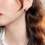 Sleek Sterling Silver Baguette-Cut Cubic Zirconia Huggie Hoop Earrings display by model