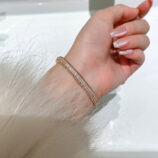 Rose gold plated Double-Row Round-Cut Tennis-Style Sterling Silver jewelry set on a wrist