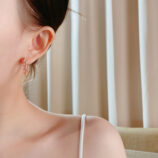 Elegant Pink Gemstone Hoop Earrings worn on a model's ear