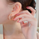 Elegant Pink Gemstone Hoop Earrings displayed on a model's ear