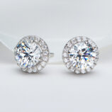 Sterling silver stud earrings with a round clear cubic zirconia center stone and halo setting.