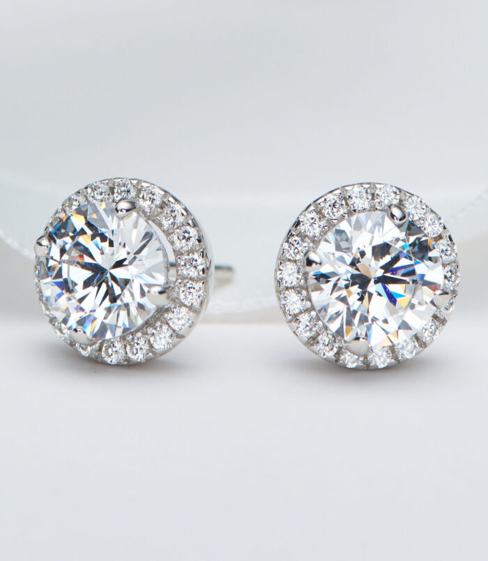 Sterling Silver Round-Cut Cubic Zirconia Halo Stud Earrings Sterling silver stud earrings with a round clear cubic zirconia center stone and halo setting.