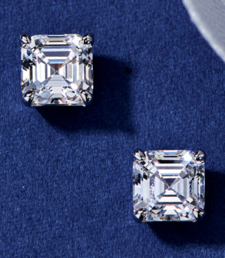 Sterling silver stud earrings with a square-cut clear cubic zirconia center stone