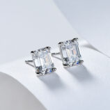 Sterling silver stud earrings with a large emerald-cut clear cubic zirconia center stone.