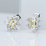 front side close up of Sterling silver stud earrings with a central yellow rectangular gemstone surrounded by clear cubic zirconia halo.