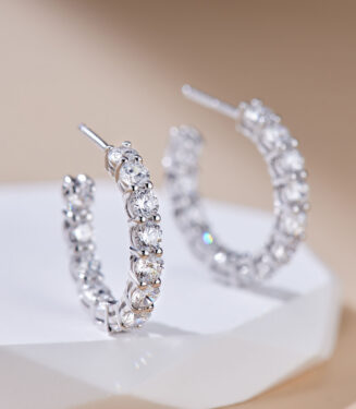Sterling silver huggie hoop earrings with pavé-set clear cubic zirconia stones.