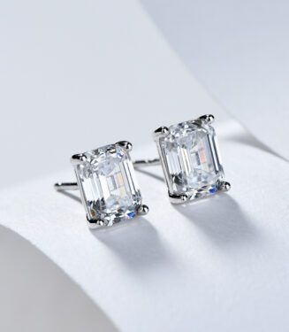 Sterling silver stud earrings with a large emerald-cut clear cubic zirconia center stone.