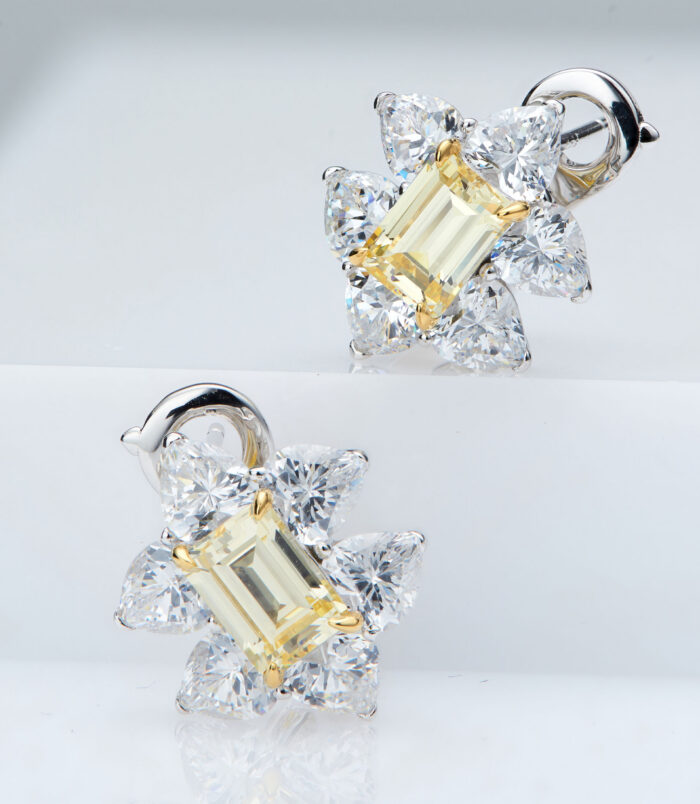 Sterling silver stud earrings with a central yellow rectangular gemstone surrounded by clear cubic zirconia halo.