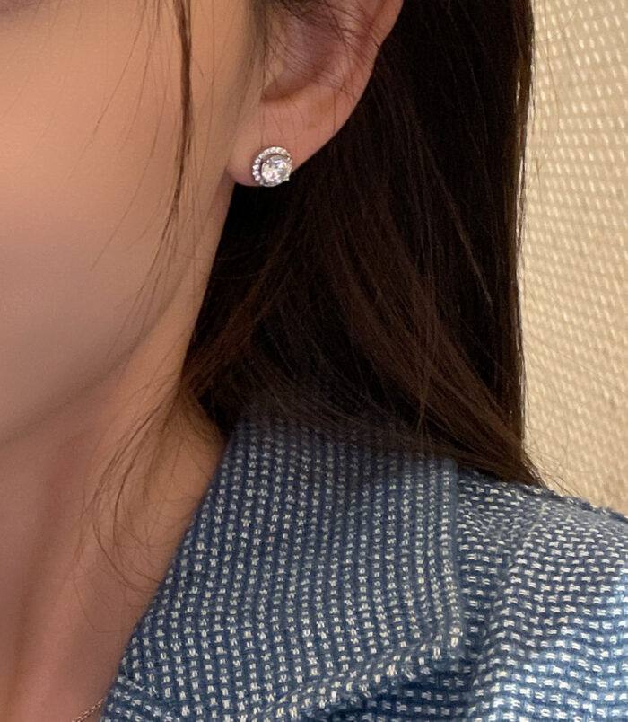 Sterling Silver Round-Cut Cubic Zirconia Halo Stud Earrings model display Sterling Silver Round-Cut Cubic Zirconia Halo Stud Earrings on model's ears