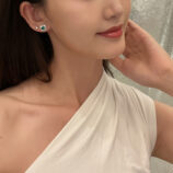 Sterling Silver green flower Halo Stud Earrings worn on a model's ear