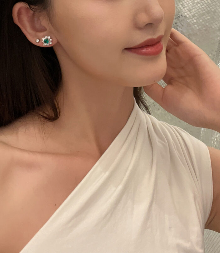 Sterling Silver green flower Halo Stud Earrings worn on a model's ear