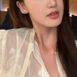 Sterling Silver red flower Halo Stud Earrings worn on a model's ear