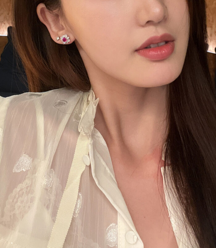 Sterling Silver red flower Halo Stud Earrings worn on a model's ear