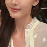 Sterling Silver red flower Halo Stud Earrings displayed on a model's ear