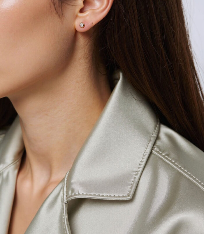 Sterling Silver mini Stud Earrings on a model's ear