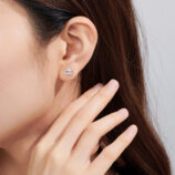 Sterling Silver Princess-Cut Zirconia Stud Earrings displayed on a model's ear