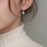 Sterling Silver Pear-Cut Cubic Zirconia Drop Earrings worn on s model's ear