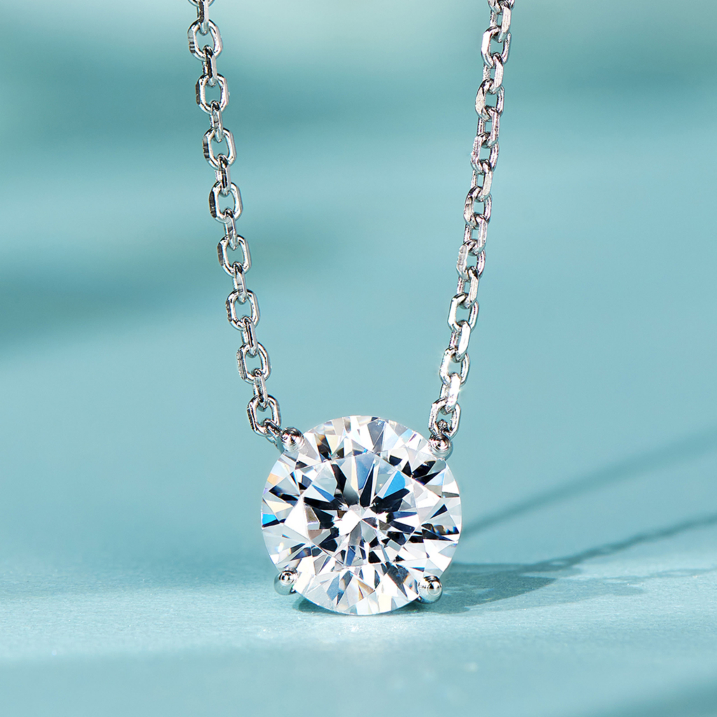 Minimalist sterling silver solitaire necklace, featuring a single round brilliant-cut white cubic zirconia stone in a four-prong setting, paired with a delicate cable chain, creating a sleek and modern look perfect for everyday wear or as a thoughtful gift.