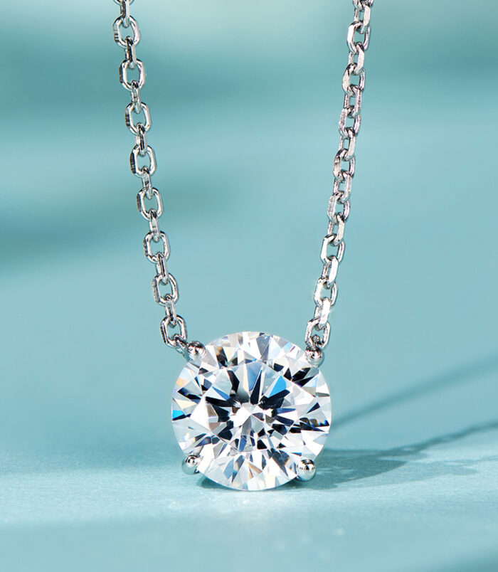 Minimalist sterling silver solitaire necklace, featuring a single round brilliant-cut white cubic zirconia stone in a four-prong setting, paired with a delicate cable chain, creating a sleek and modern look perfect for everyday wear or as a thoughtful gift.