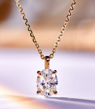 Chic gold-plated sterling silver necklace featuring a large oval-cut white cubic zirconia stone as the centerpiece, secured in a four-prong setting, paired with a classic rope chain, creating a timeless and sophisticated look perfect for adding a touch of elegance to any outfit.