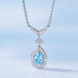 Exquisite sterling silver necklace, featuring a V-shaped top adorned with round brilliant-cut white cubic zirconia stones, suspending a pear-shaped blue cubic zirconia stone in a halo setting surrounded by round brilliant-cut white cubic zirconia stones, paired with a classic cable chain, creating a sophisticated and glamorous look perfect for adding a touch of luxury to any outfit.