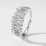 Stunning cluster-style sterling silver ring featuring multiple round brilliant-cut white cubic zirconia stones set in an intricate openwork band, creating a sparkling and luxurious look perfect for adding a touch of glamour to any outfit.